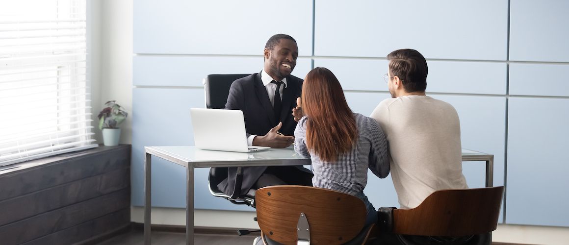 Financial advisor or coach meeting with clients.