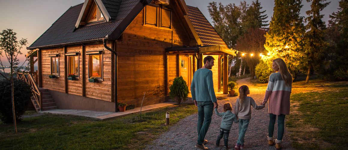 Family in front of their cabin they just bought.