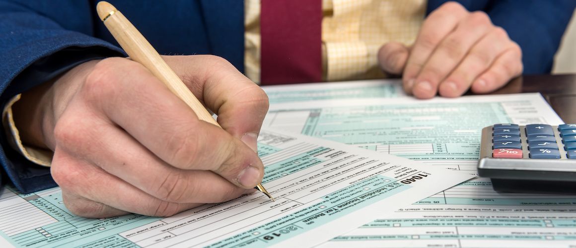 Person filling out tax forms.