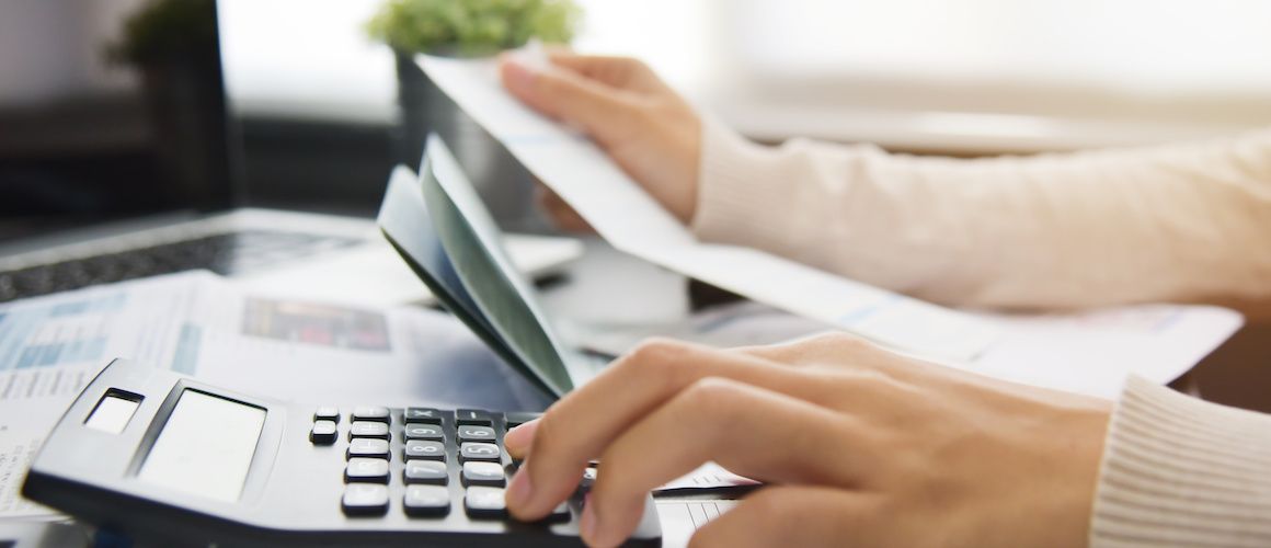 Woman balancing her checkbook.